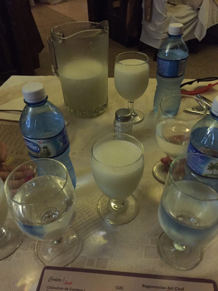 a group of glasses and bottles of water on a table