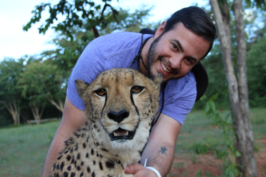 a man holding a cheetah