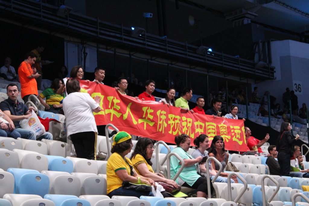 a group of people holding a banner in a stadium