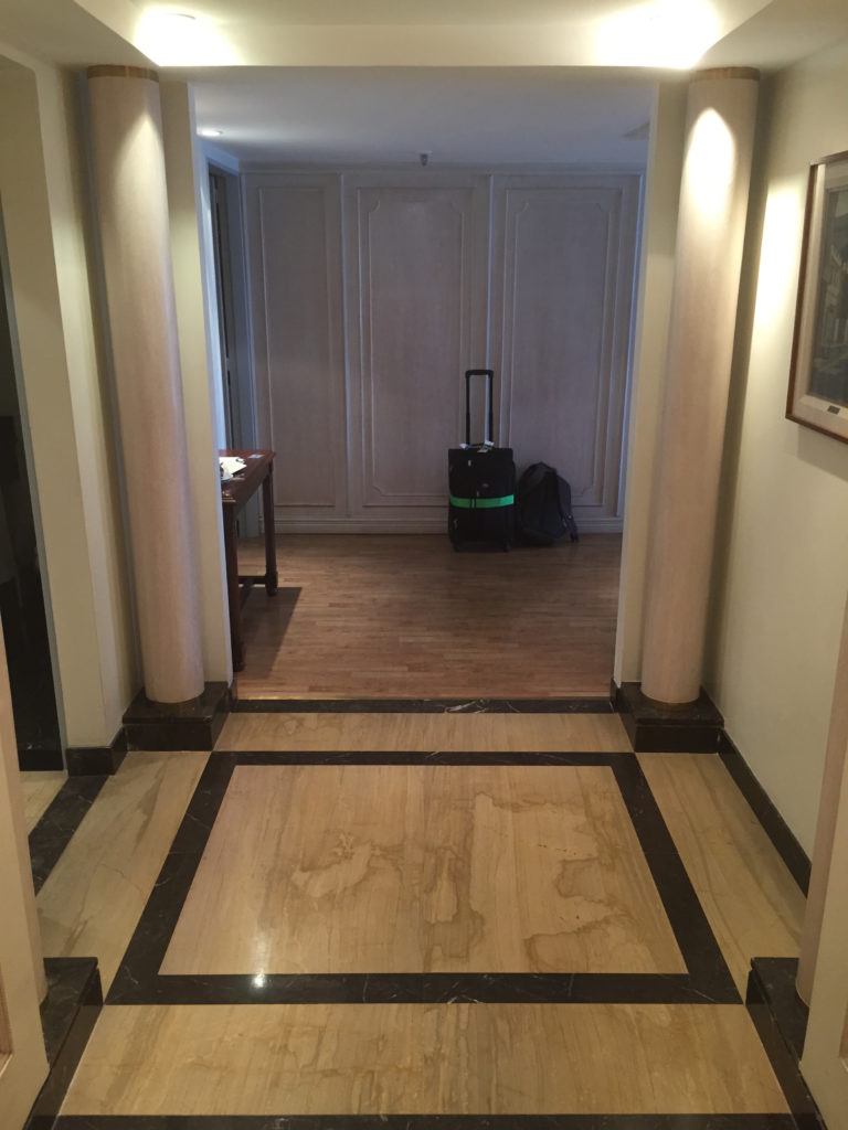 a hallway with a black and white tile floor