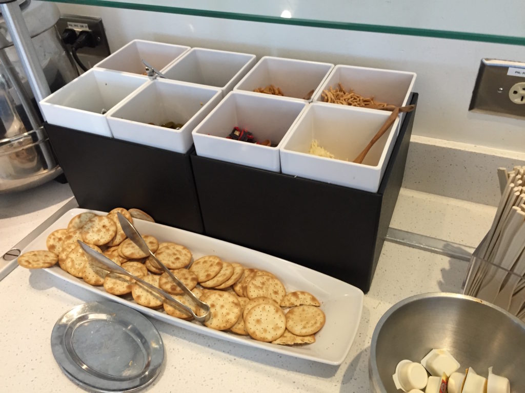 a tray of crackers and utensils in a container