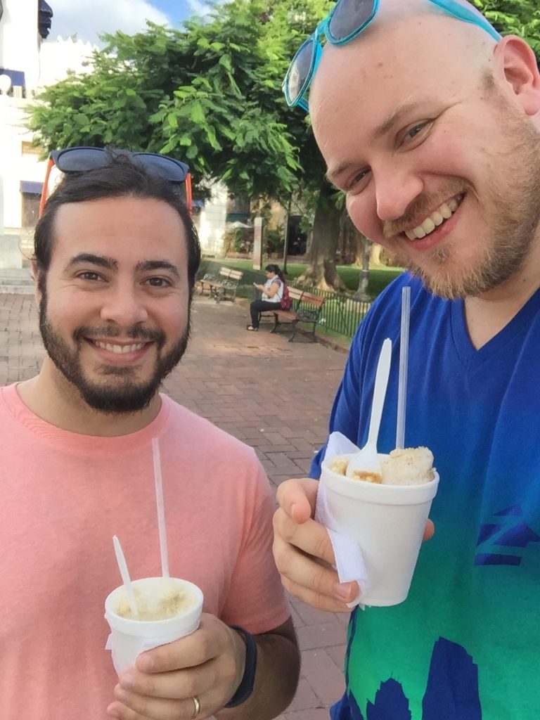 two men holding cups of ice cream