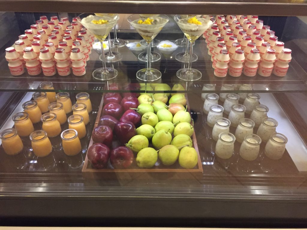 a display case with fruit and drinks