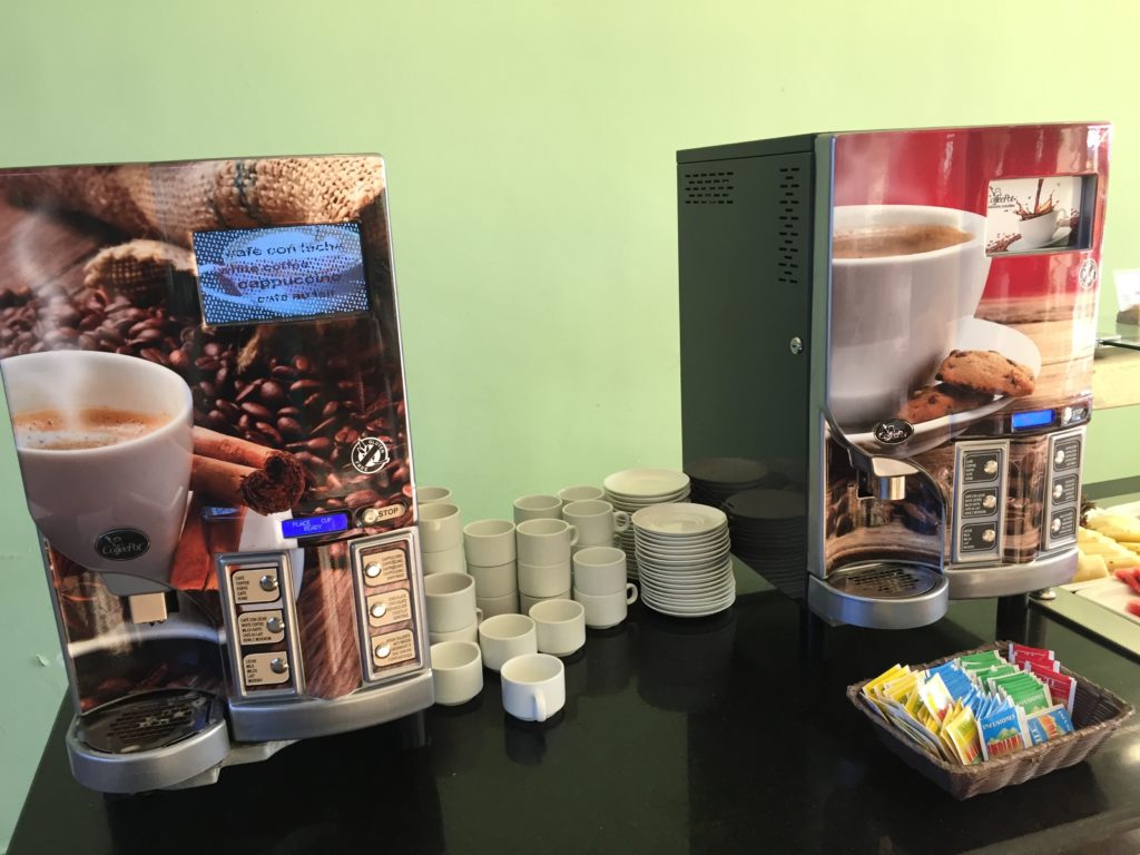 a coffee machine with cups and tea bags