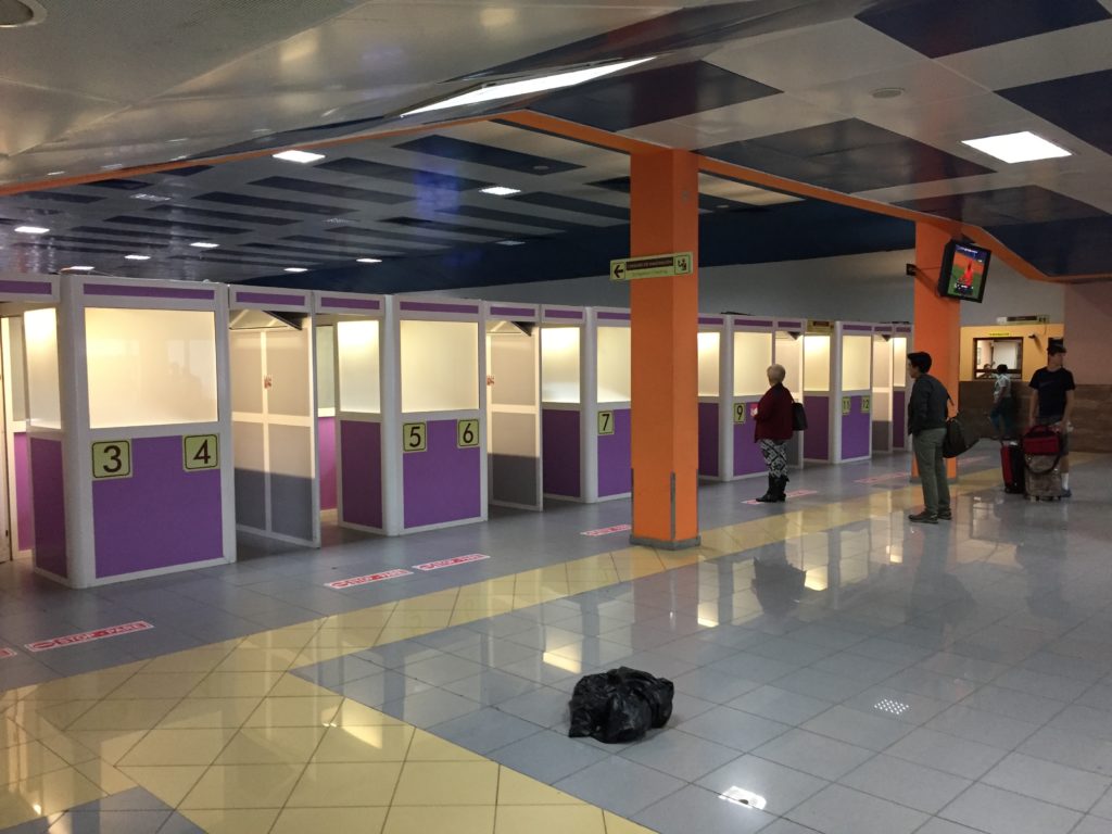a group of people standing in a row of purple and white cubicles