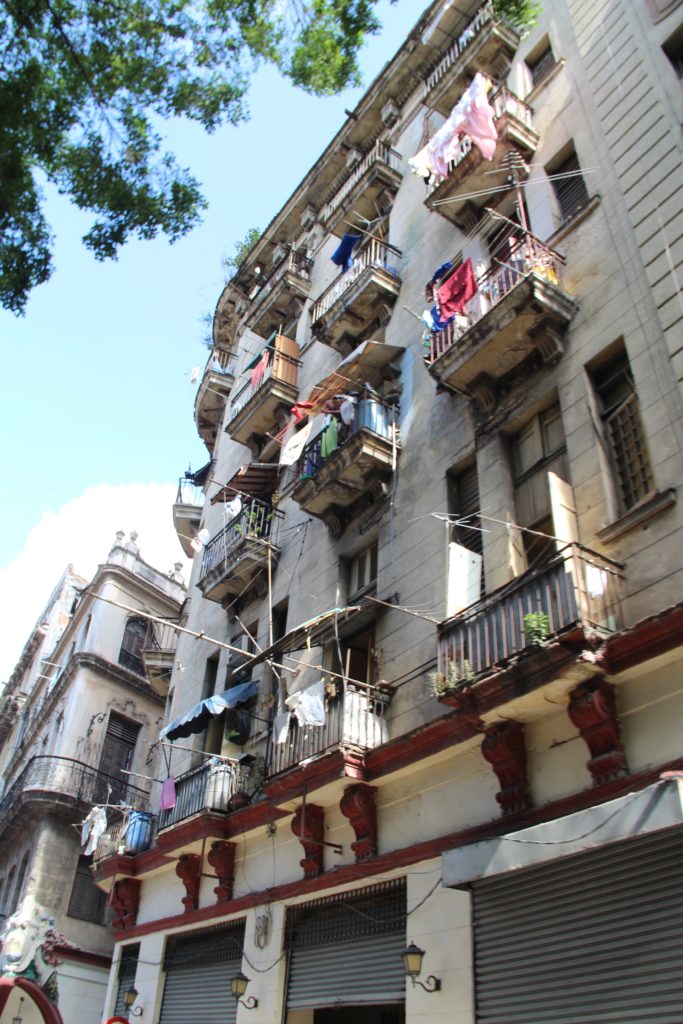 a building with clothes on the balconies