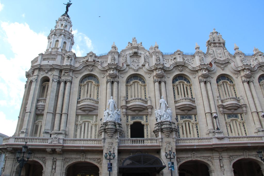 a large building with statues on top of it