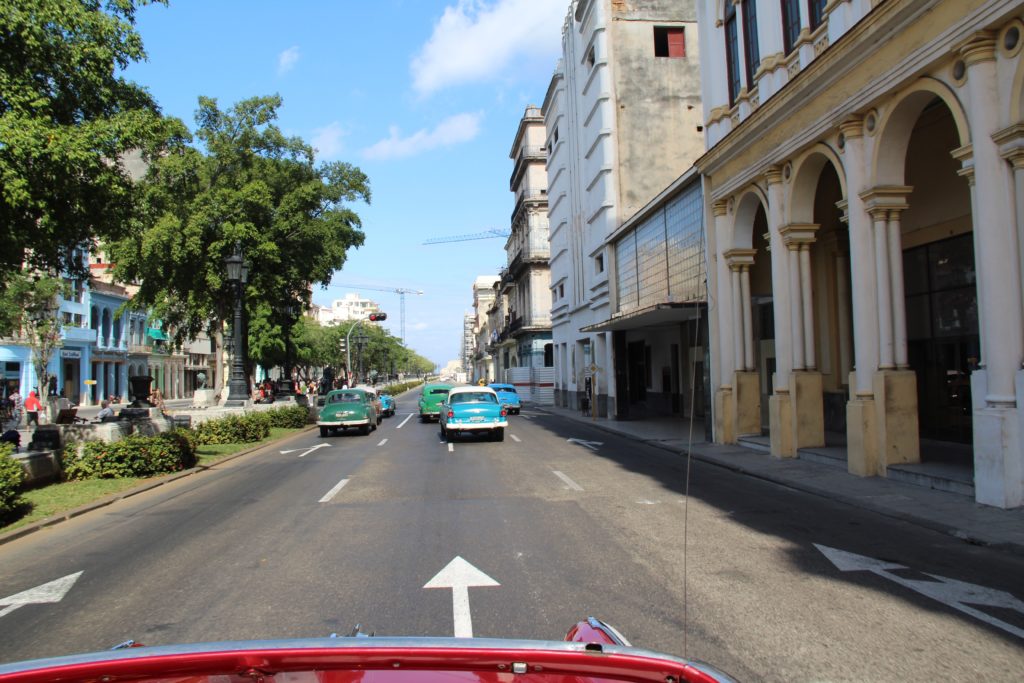 a group of cars driving down a street