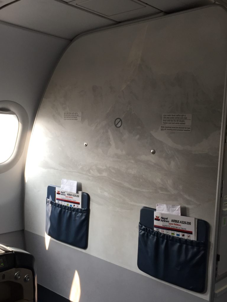 a plane with a window and a pair of pockets