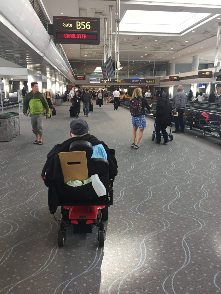a man in a wheelchair in an airport