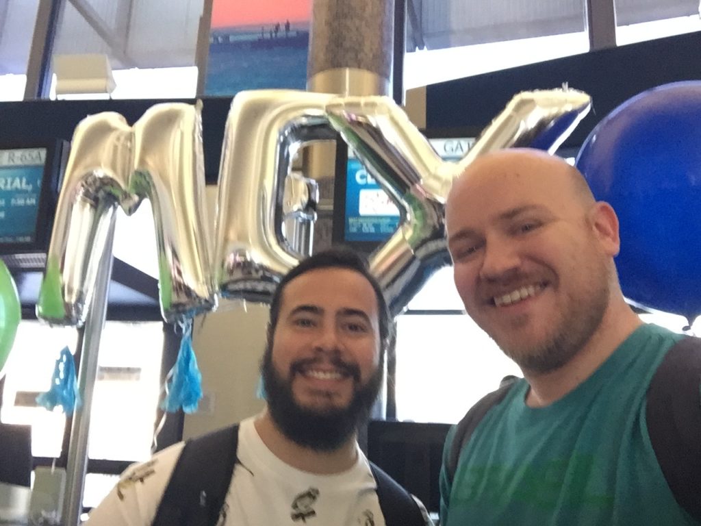 two men standing in front of balloons