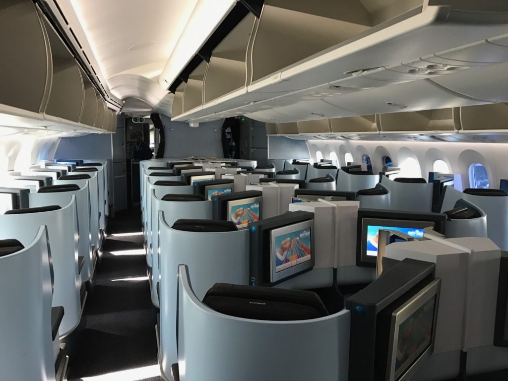 an airplane with rows of seats and monitors