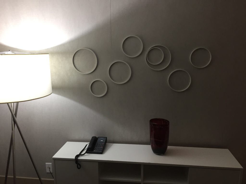 a phone and a lamp on a white shelf