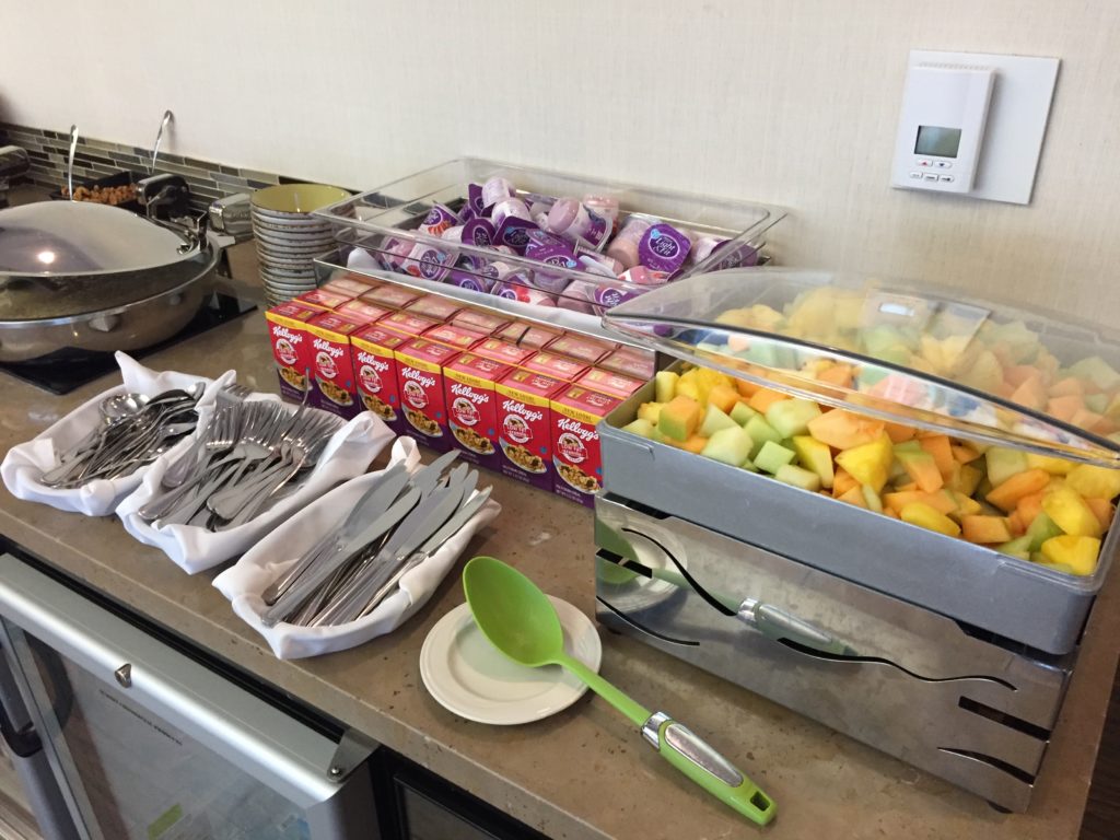 a buffet table with food and utensils