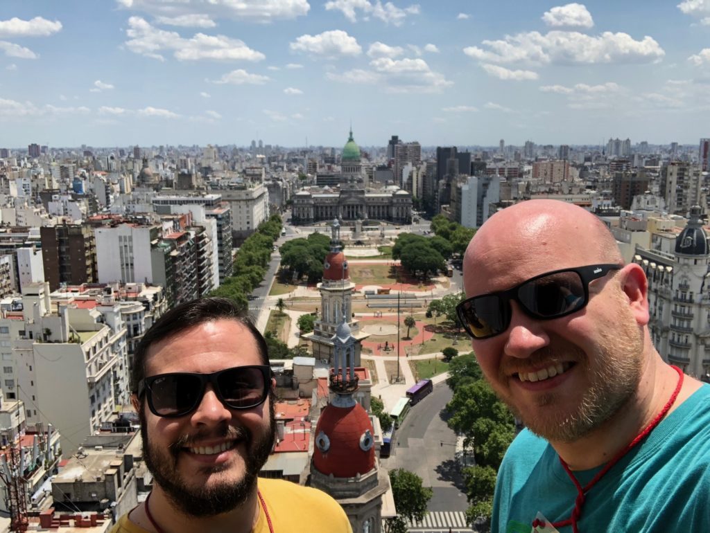 two men taking a selfie in a city