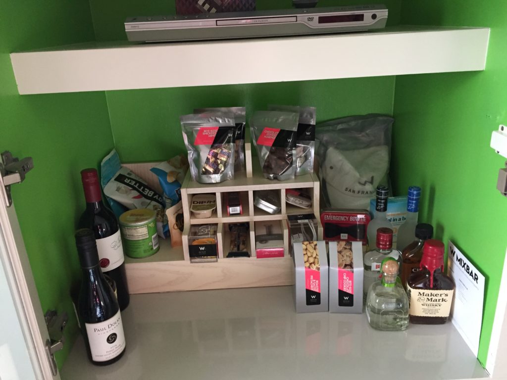 a shelf with bottles of liquor and other items