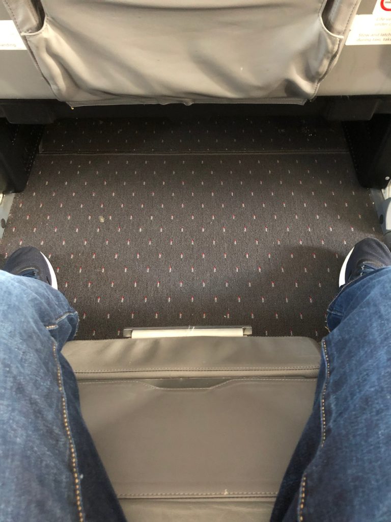 a person's legs and feet in a seat