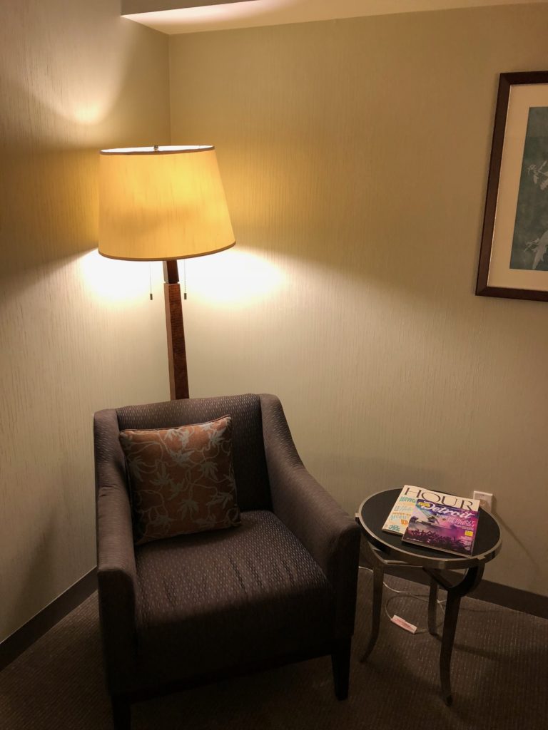 a lamp next to a chair