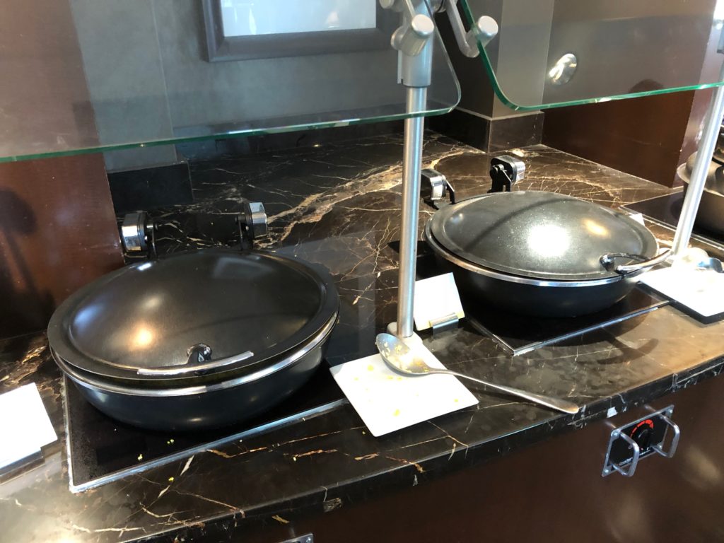 a black pans on a marble counter