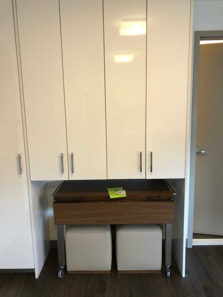 a white cabinet with silver handles