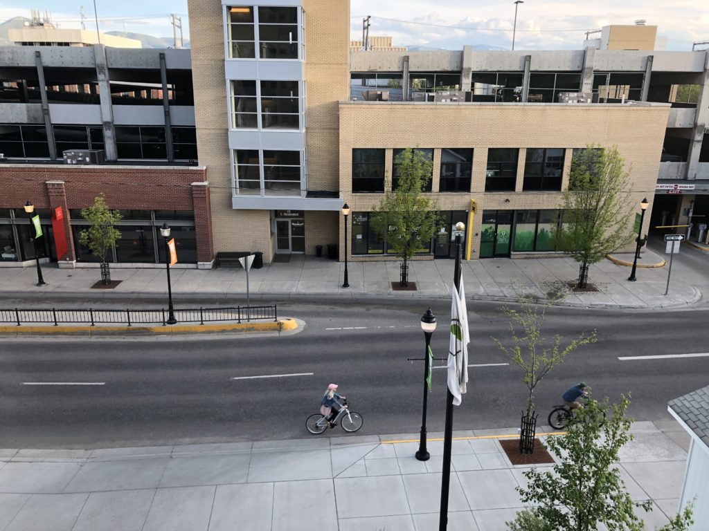 a street with a bicycle and a building