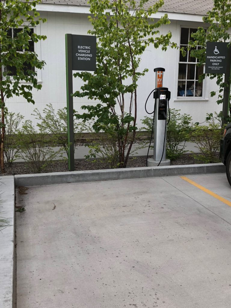 a car parked next to a charging station