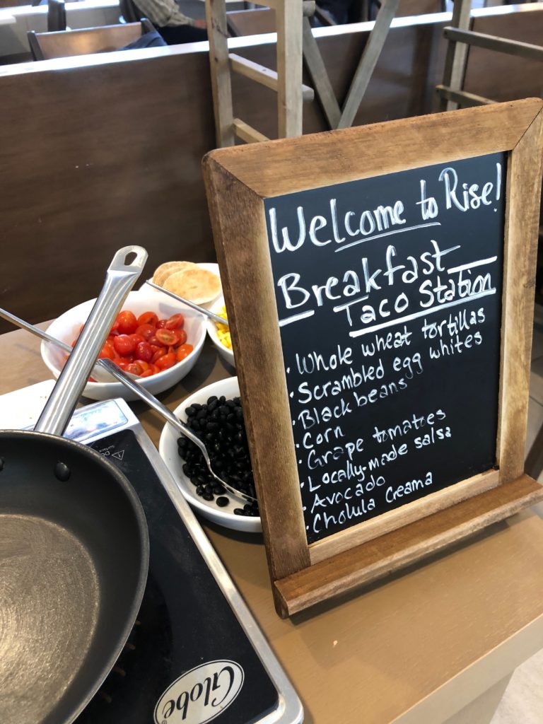 a sign with a wooden frame and a pan in front of it