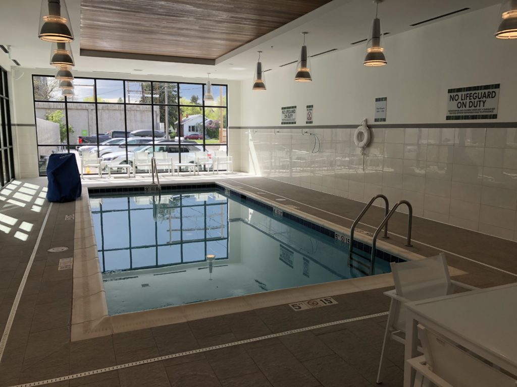 a indoor swimming pool with a white tile floor