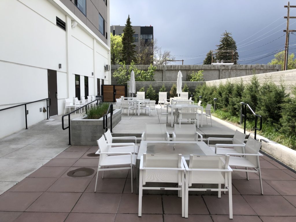 a patio with chairs and tables