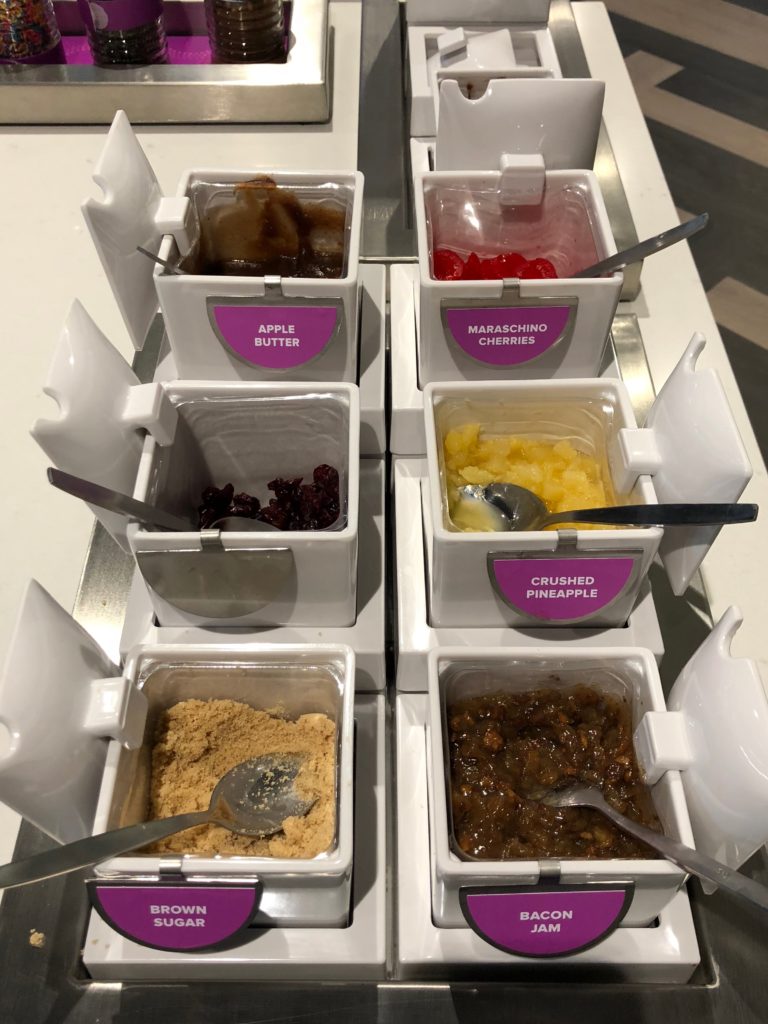 a group of containers with different toppings
