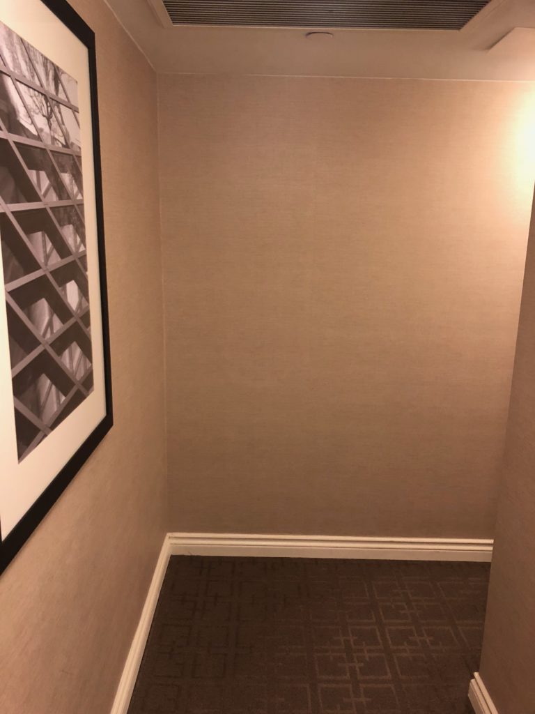 a hallway with a picture on the wall