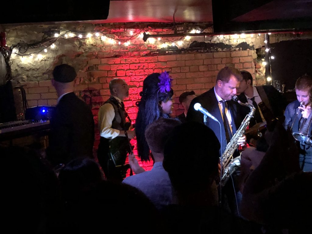 a man playing a saxophone in front of a crowd