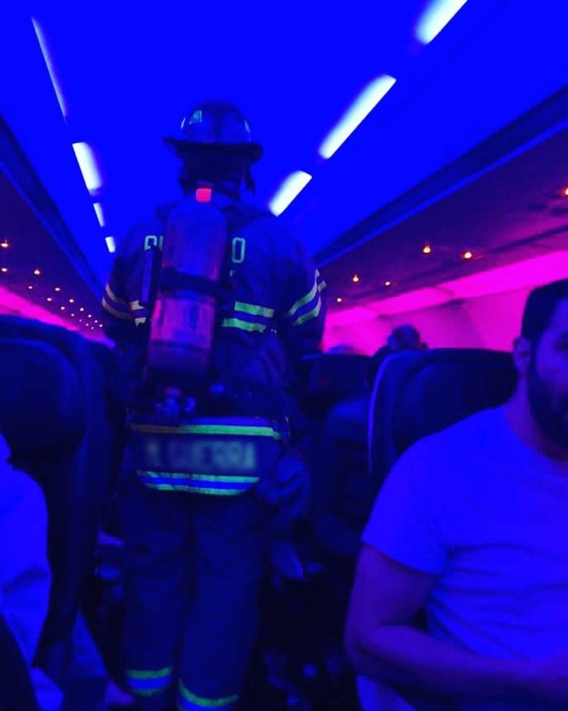 a firefighter standing in a plane