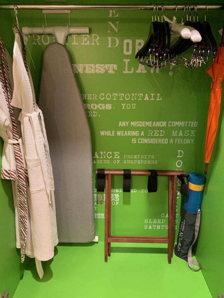 a swinger and clothes rack in a room