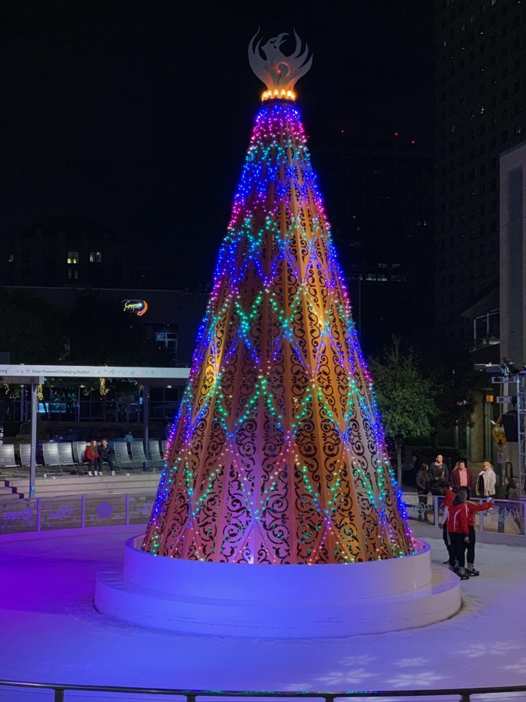 a large christmas tree with colorful lights