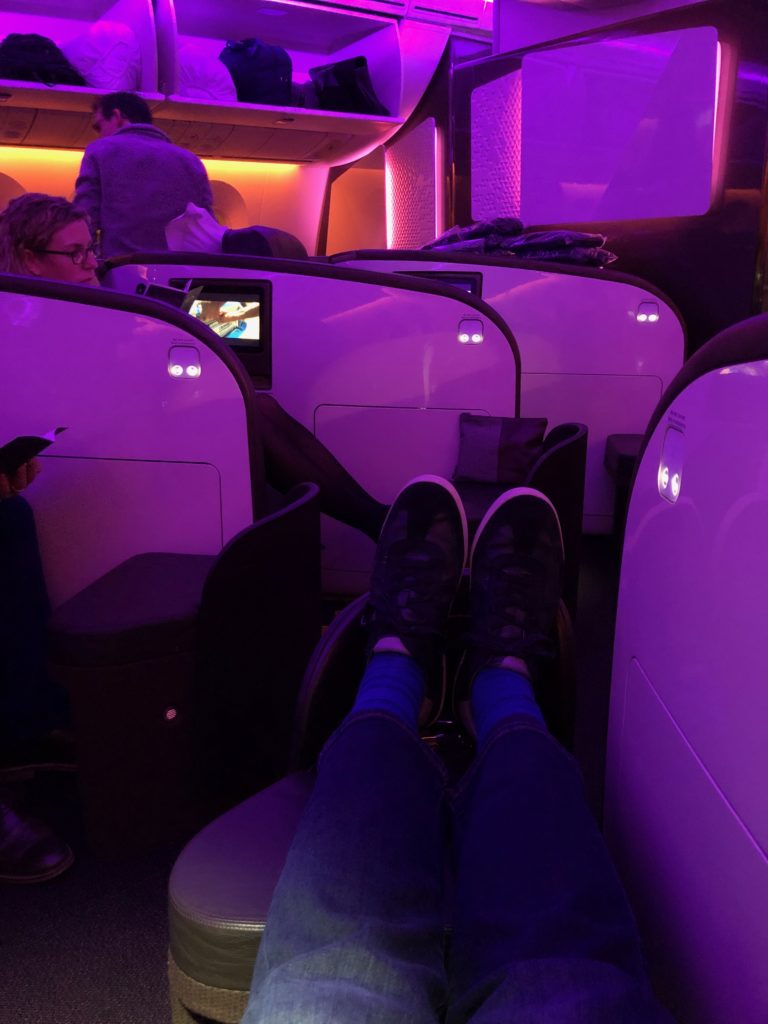 a person's legs in a chair in an airplane