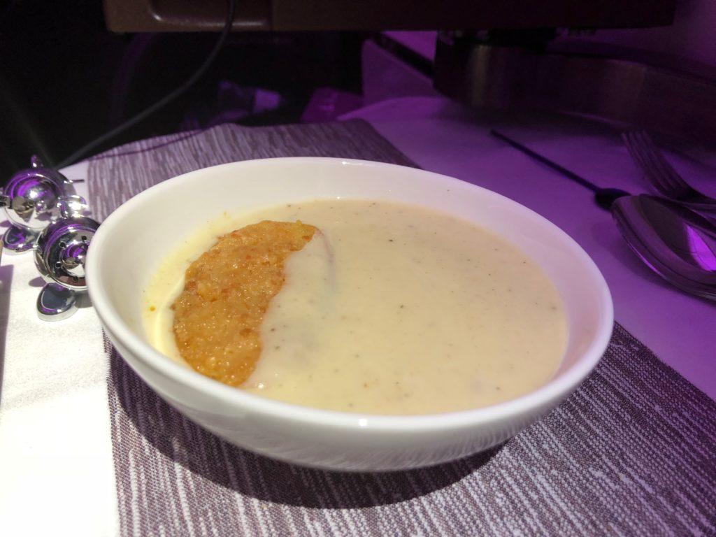 a bowl of soup with a piece of food in it