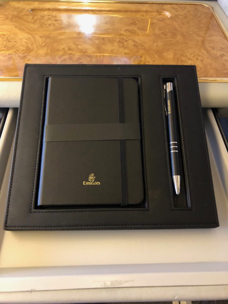 a black leather case with a pen and a notebook