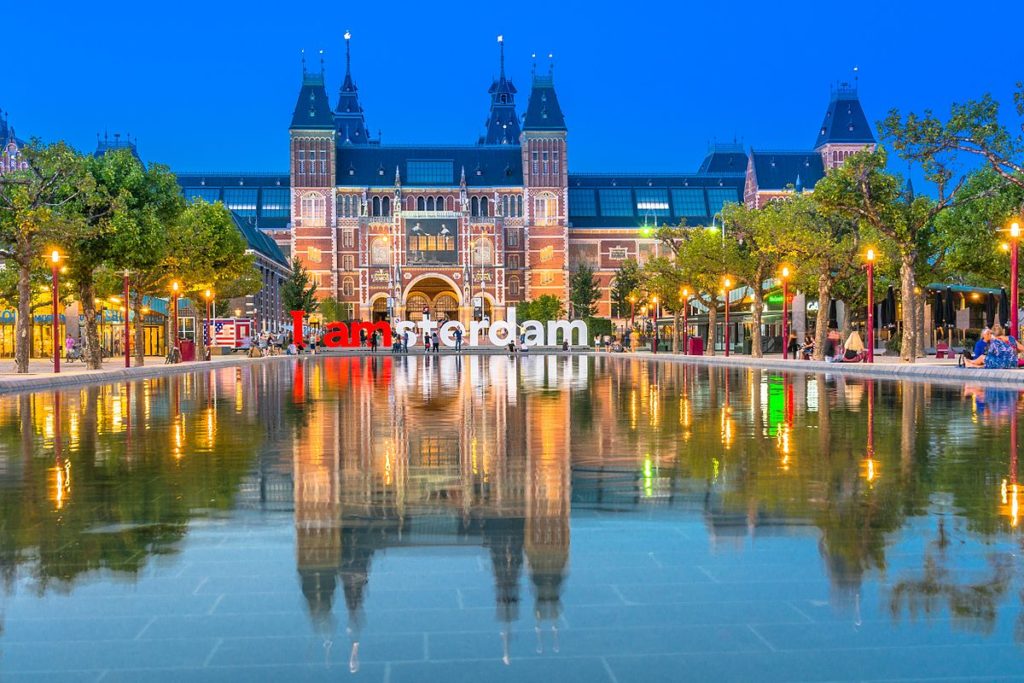 a large building with a pool of water with Rijksmuseum in the background