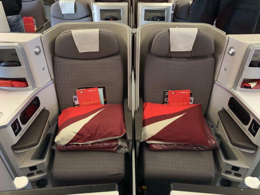 a two seats with pillows on them