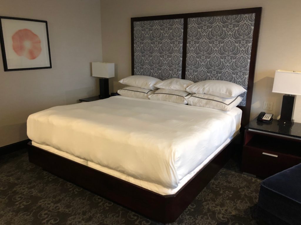 a bed with pillows in a room