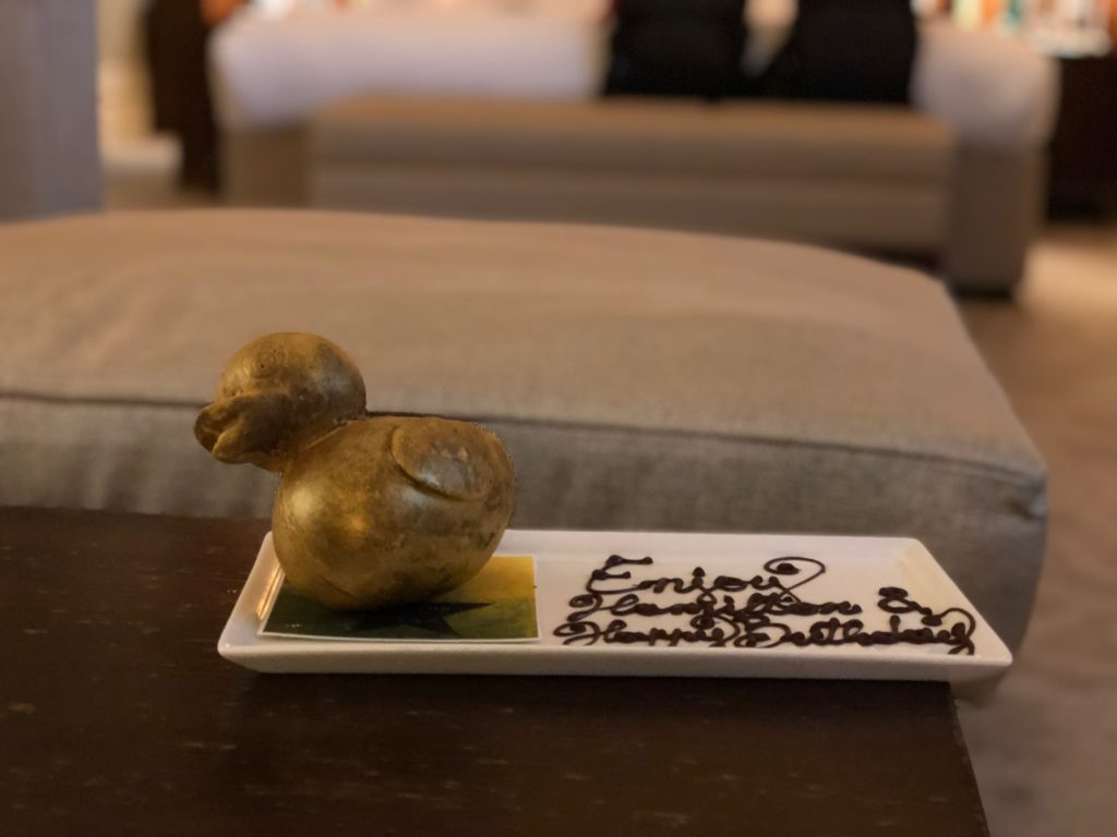 a small duck shaped object on a rectangular plate