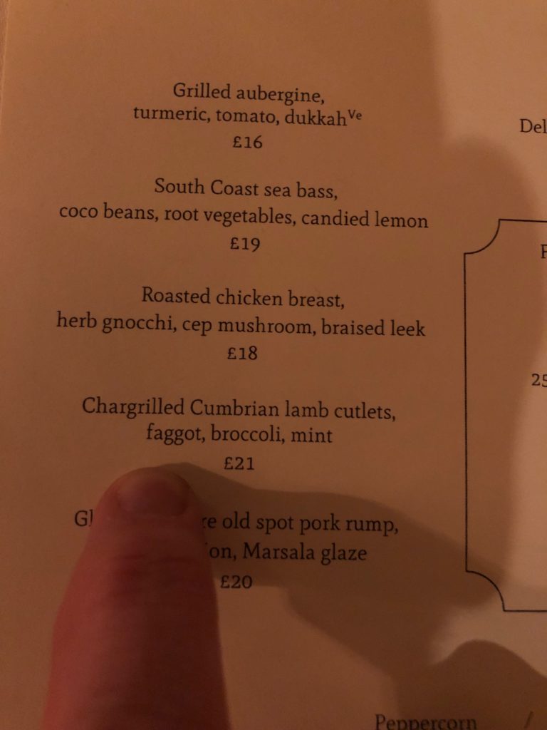 a finger pointing at a menu