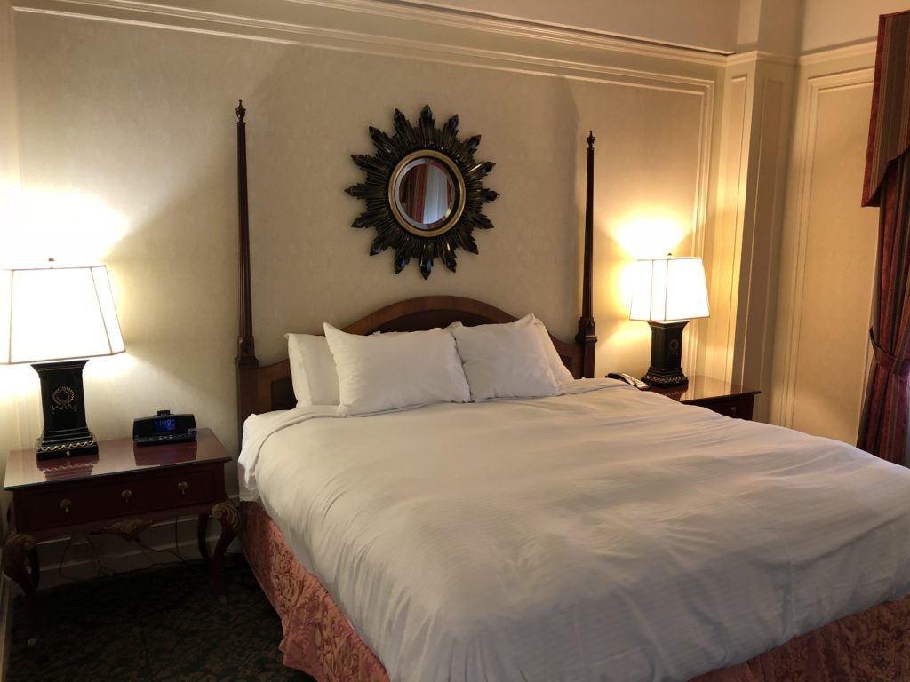 a bed with a mirror above it