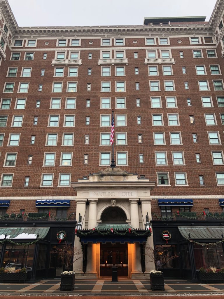 a large brick building with a flag on the front