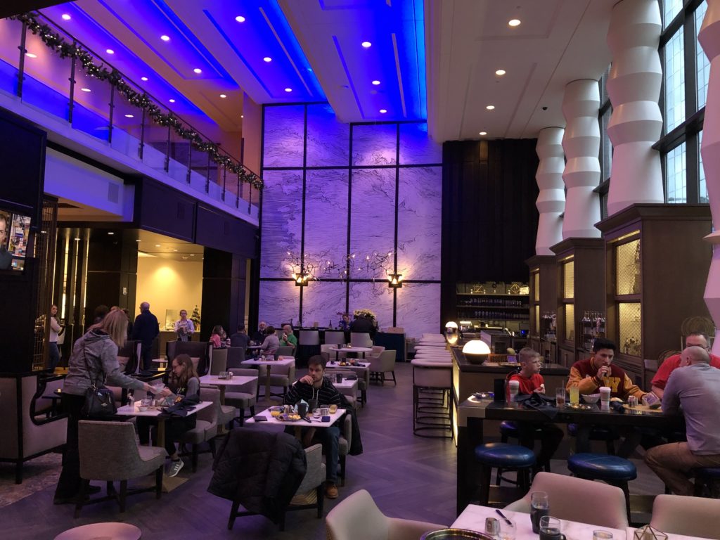 a group of people sitting at tables in a restaurant