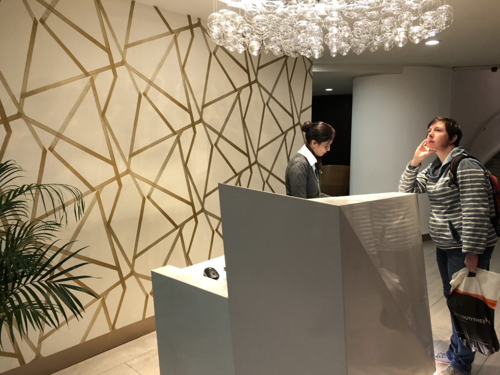 a woman standing at a reception desk