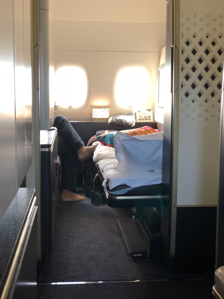 a person's feet on a bed in a plane
