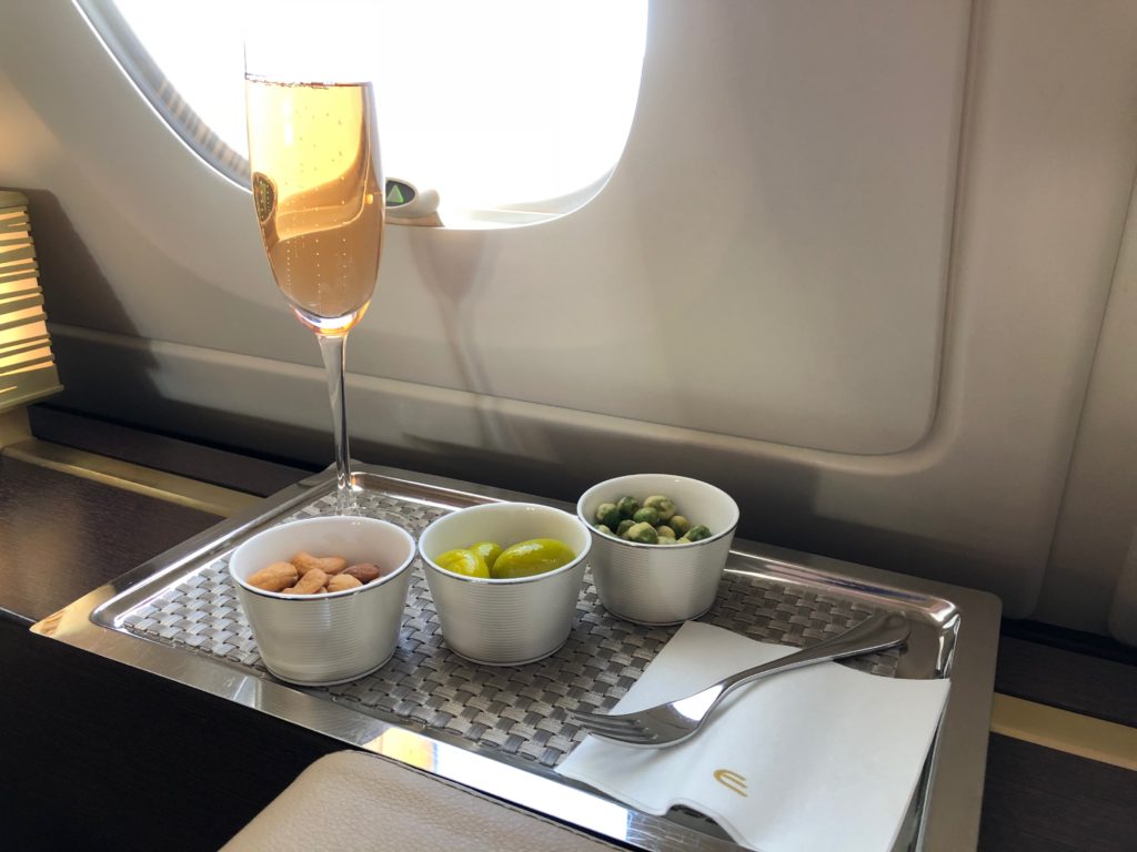 a tray with food and a glass of champagne