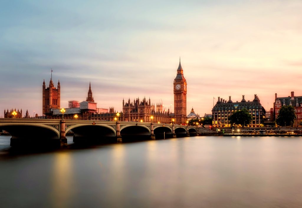 a bridge over a river with a clock tower and a clock tower